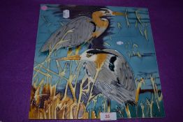 A large ceramic tile of two heron birds signed Pierce