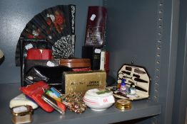 A selection of curios and dressing items including fans coin purse and manicure set