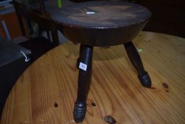 A traditional poker work tri legged stool, possibly Satanic decoration