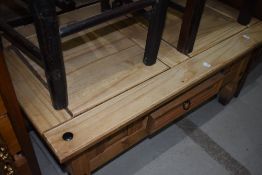 A rustic coffee table with frieze drawer