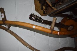 A vintage grass cutting sythe with traditional design