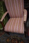 A carver dining room chair with mahogany frame and corduroy seat