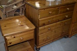 A modern pine bedroom chest of two over three drawers and a bedside unit