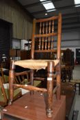 A traditional rush seated spindle back dining chair