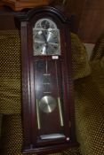 A reporduction mahogany effect wall clock