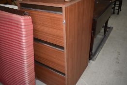 A laminate three drawer filing cabinet