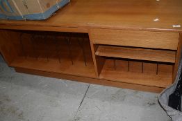 A vintage teak hifi sideboard having dividers for LP and singles, and cassette drawer