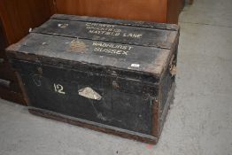 A vintage shipping trunk, worn labels