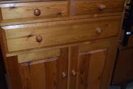 A modern pine cabinet, two over one drawer and lower cupboard section
