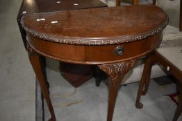 An early to mid 20th Century mahogany demi lune hall table