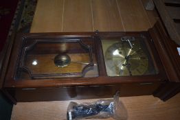 A reproduction mahogany effect wall clock , having brass Metamec face