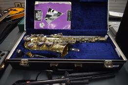 An AK Amatikraslice Alto Saxophone , model AAS 22 , hard case and folding stand