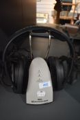 A pair of Sennheiser SRS headphones and stand