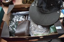 A box containing weather proof hats and knife sheaths