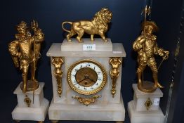 An impressive marble and ormolu mantle clock and garniture set having conquistador figures and