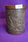 A hand carved Chinese bamboo brush pot depicting man of horse back 17cm tall