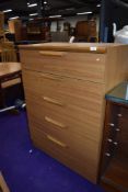A laminate chest of five drawers