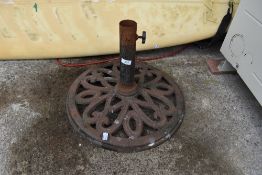 A cast iron garden parasol umbrella stand
