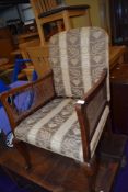 An early 20th Century easy chair having bergere sides and ball and claw feet
