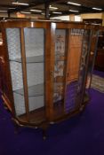 An early to mid 20th Century walnut demi lune display cabinet