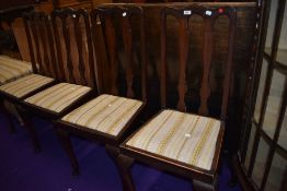 A set of four early 20th Century stained frame double vase back dining chairs