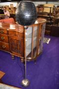 A modern standard lamp having basket style shade