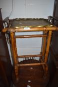 A Chinese tea table having brass chase worked dish top with gilt decorated bamboo frame