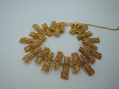 A 1970's yellow metal articulated bracelet in the modernist rustic style, no marks but previously
