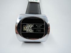 A 1970's automatic wrist watch by Buler having three white rotating window dials with Arabic