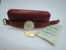 A gent's 1960's 9ct gold wrist watch by Baume having a baton and Arabic numeral dial to champagne