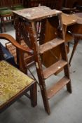 A set of vintage wooden step ladders, labelled for Slingsby