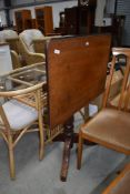 A late Victorian tilt top tea table having turned base