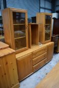 A modern light stained side board or dresser base by Ercol with glazed cabinets