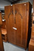 An Edwardian wardrobe with oak carcass and decorative front panel 91cm wide