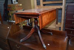 A small tea or similar wine table having metal claw feet