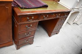 A modern office knee hole desk having solid wood carcass with green leather top in great condition