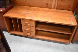 A vintage teak effect entertainment stand, width approx. 122cm