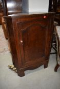 An oak corner cupboard base unit