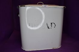 A vintage enamel kitchen bread bin