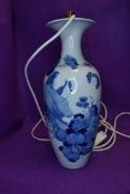 An antique Chinese export porcelain vase with white ground decorated with fantasy landscape and