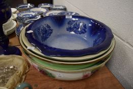 A selection of large ceramic water wash bowls including blue and white wear and transfer printed