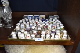 A selection of collectable thimbles including printed decorated and metal also Royal Crown Derby