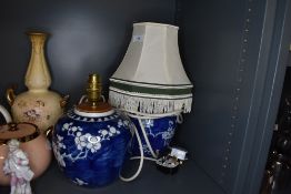 Two traditional Chinese export ginger jars as lamps being hand decorated in cherry blossom