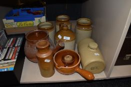 A selection of earthen ware salt glazed jugs and flagons including spouted lidded pot