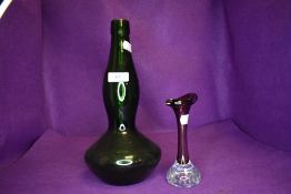 A bell bottom green glass wine bottle and a similar art glass posy vase