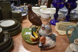 A selection of bird themed ceramics including Royal Doulton grouse decanter and a set of three