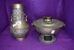 Two brass Chinese themed items a twin handle vase and similar spirit burner