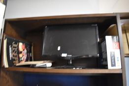 A Sony Bluetooth car radio/cd player, a flat screen television, a vintage Casio calculator and a