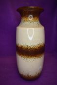 A floor standing west German pottery vase in naturalistic glaze