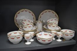 A partial Wearing and Gillow tea service comprising of egg cups,cups and saucers,jug and plates